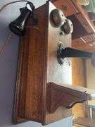 Antique wooden wall-mounted telephone