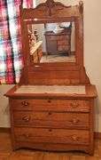 Antique American Eastlake three-drawer oak dresser with a carved mirror