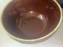 Vintage stoneware mixing bowl with a brown glaze and picket fence design. USA 9n the bottom