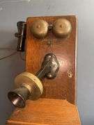Antique wooden wall-mounted telephone