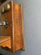 Antique wooden wall-mounted telephone