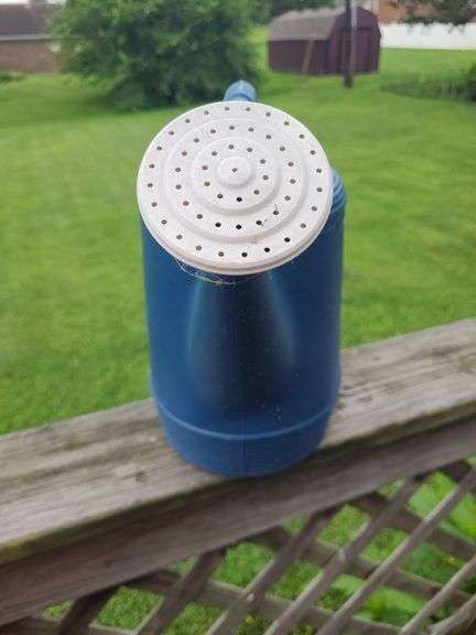 Blue plastic watering can