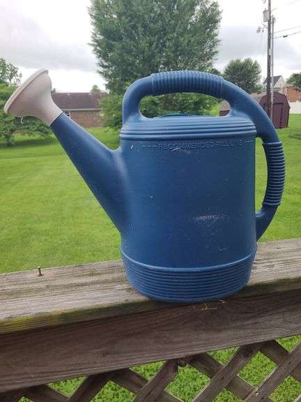 Blue plastic watering can