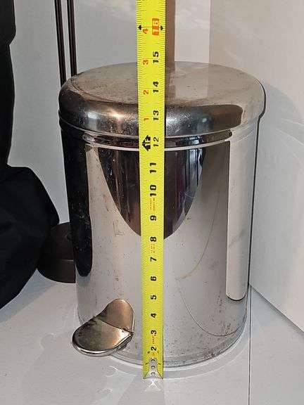 Close tote, toilet paper holder, & metal trash can.