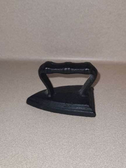 Cast mini iron and tin candle holder with honeycomb candle.