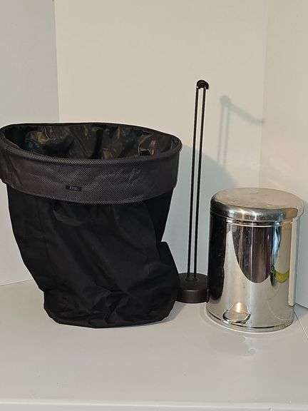 Close tote, toilet paper holder, & metal trash can.