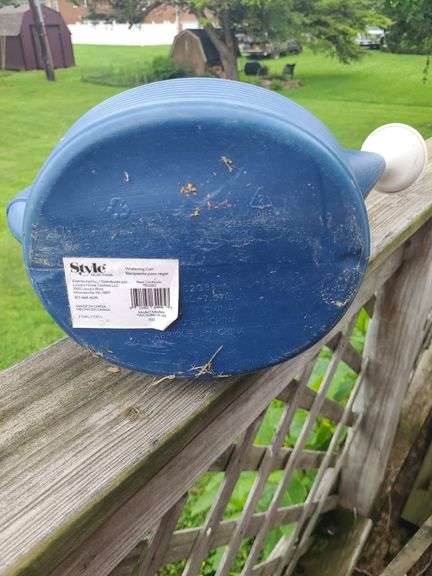 Blue plastic watering can