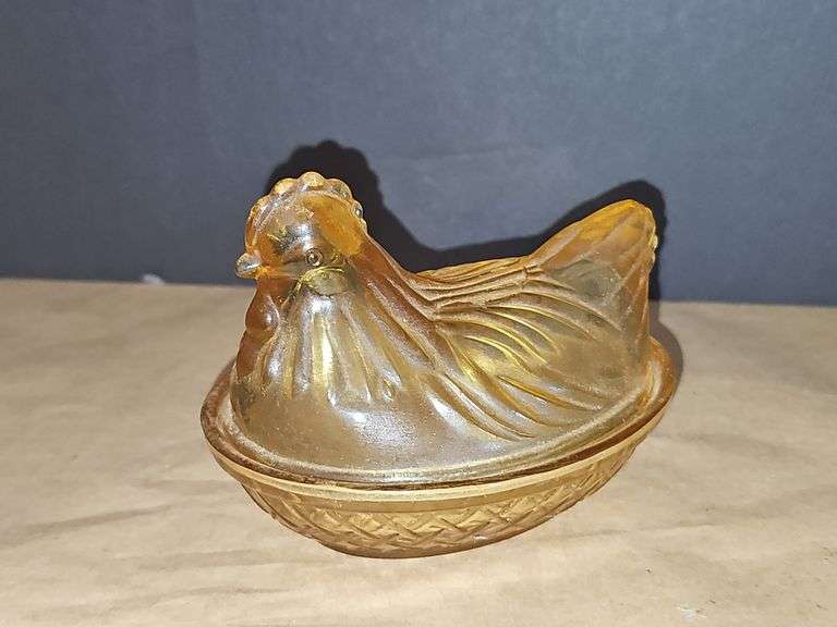 Small amber colored hen on a nest