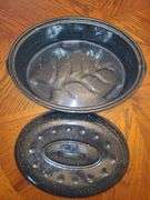 Black and enamel roasting pan with lid.