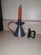 Cast mini iron and tin candle holder with honeycomb candle.