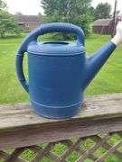Blue plastic watering can