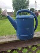 Blue plastic watering can