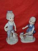 Homci man & woman figurines and little girl figurines.