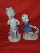Homci man & woman figurines and little girl figurines.