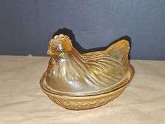 Small amber colored hen on a nest