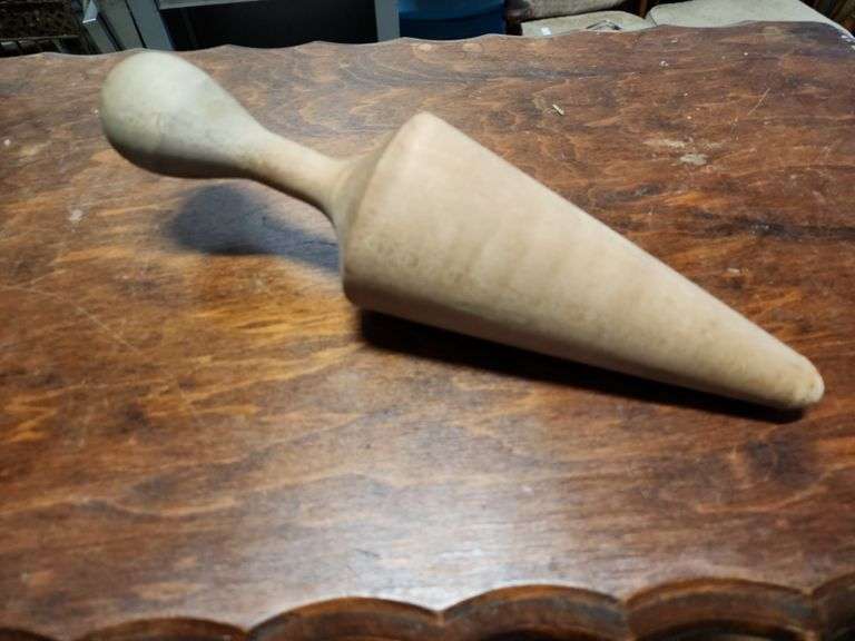 vintage aluminum cone strainer with a metal stand and wooden pestle