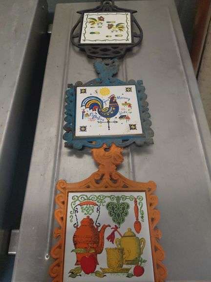 Folk art cast iron and ceramic tile trivets