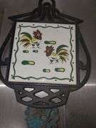 Folk art cast iron and ceramic tile trivets