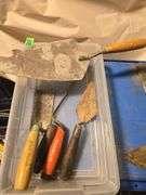 variety of used concrete and masonry hand tools.
