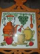 Folk art cast iron and ceramic tile trivets