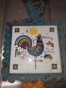 Folk art cast iron and ceramic tile trivets