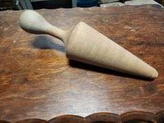 vintage aluminum cone strainer with a metal stand and wooden pestle