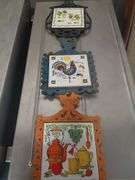 Folk art cast iron and ceramic tile trivets