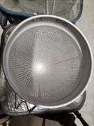 vintage aluminum cone strainer with a metal stand and wooden pestle