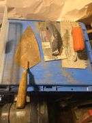 variety of used concrete and masonry hand tools.