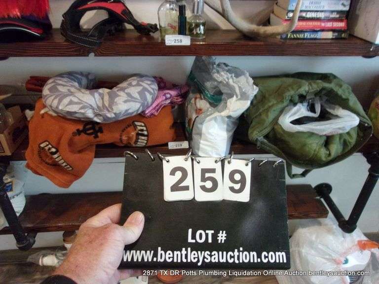 CONTENTS OF SHELF: THROW BLANKET, NECK PILLOW, MENS UNDERWEAR, CAMCORDER IN GREEN BAG