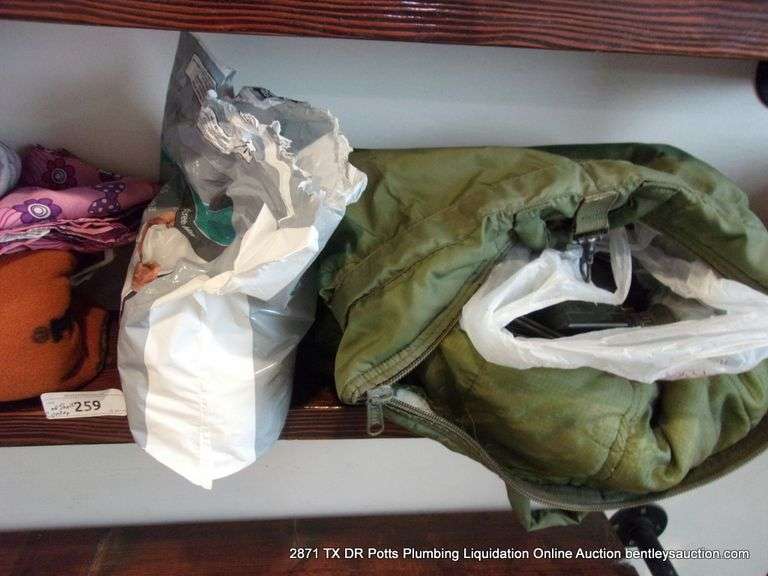 CONTENTS OF SHELF: THROW BLANKET, NECK PILLOW, MENS UNDERWEAR, CAMCORDER IN GREEN BAG