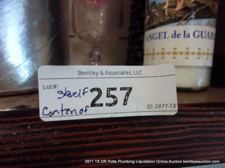 CONTENTS OF SHELF: BAGS, OLD PHONES, WONDER WOMAN FUNKO POP, CANDLES, PICTURE FRAMES