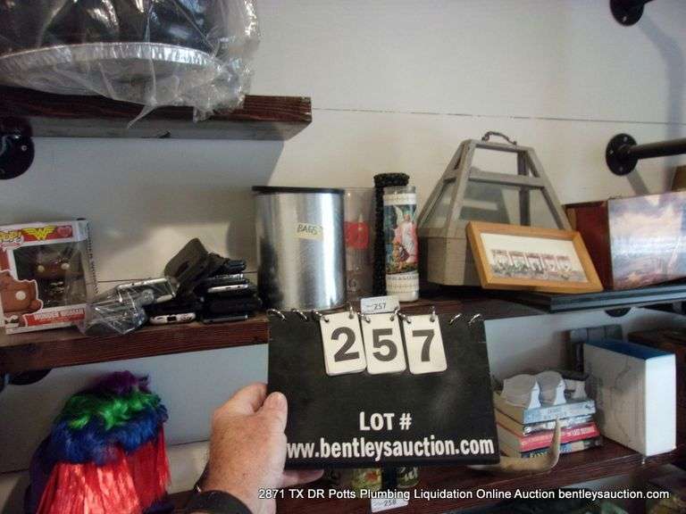 CONTENTS OF SHELF: BAGS, OLD PHONES, WONDER WOMAN FUNKO POP, CANDLES, PICTURE FRAMES