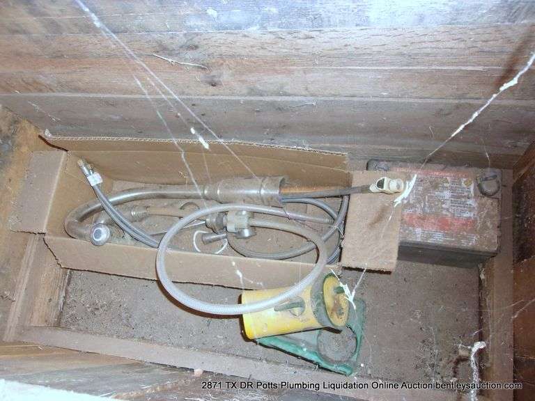 CONTENTS OF WOOD BOXES IN CORNERS - SPRINKLER, BATTERY, FLOWERING SUPPLIES