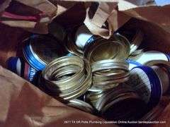 CONTENTS OF SHELVES: TUPPERWARE LIDS, GULF WAX, STICKERS, HAND DÉCOR, GLASS JARS, HEAT BATH