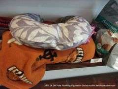 CONTENTS OF SHELF: THROW BLANKET, NECK PILLOW, MENS UNDERWEAR, CAMCORDER IN GREEN BAG