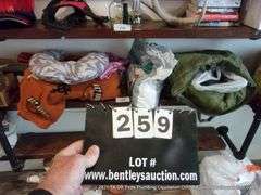 CONTENTS OF SHELF: THROW BLANKET, NECK PILLOW, MENS UNDERWEAR, CAMCORDER IN GREEN BAG