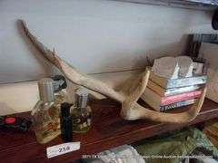 CONTENTS OF SHELF: HATS, COLOGNE, BOOKS, HORN, DOG HARNESS, I-ZOOM