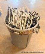 SMALL TRASH BIN FULL OF HANGERS