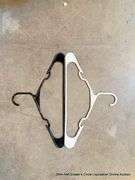 SMALL TRASH BIN FULL OF HANGERS