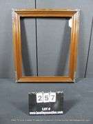 DARK-STAINED, CARVED WOODEN FRAME 25 X 29
