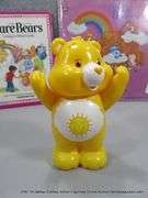 LOT: (3) CARE BEARS MERCH "CARE FOR YOU" VINYL, SUNSHINE BEAR & BOOK