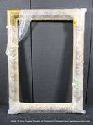GOLD PAINTED, CARVED ORNATE WOODEN FRAME - (WRAPPED IN PLASTIC) 27 X 37