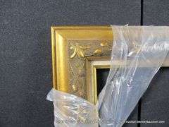GOLD PAINTED, CARVED ORNATE WOODEN FRAME - (WRAPPED IN PLASTIC) 27 X 37