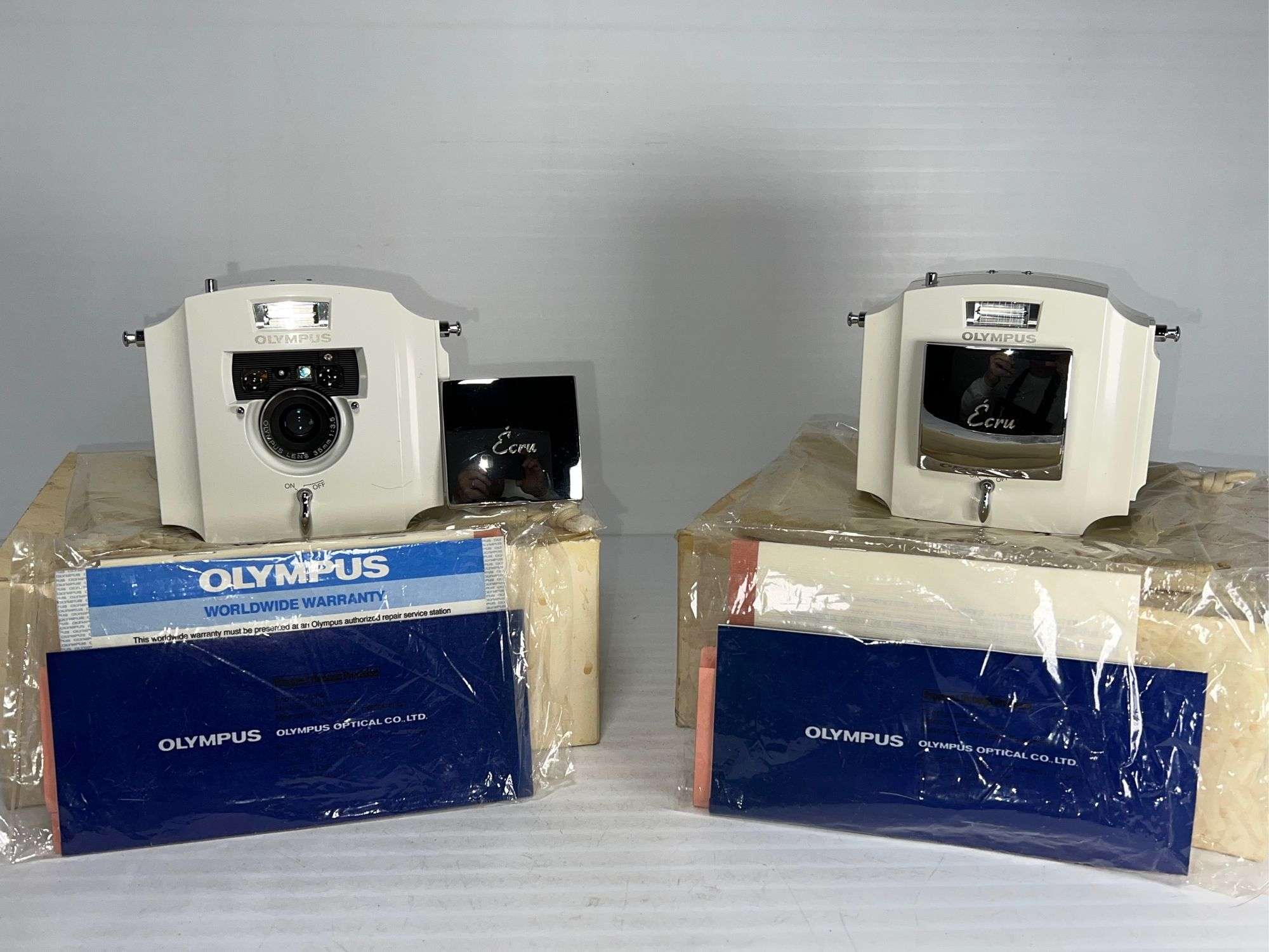 Olympus Ecru 35 mm cameras-(2X$) - Bid-Assets Online Auctions