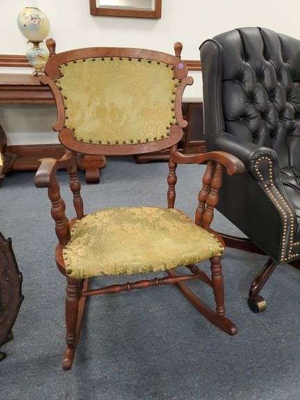 English style wooden rocking chair with fabric covered seat and back.