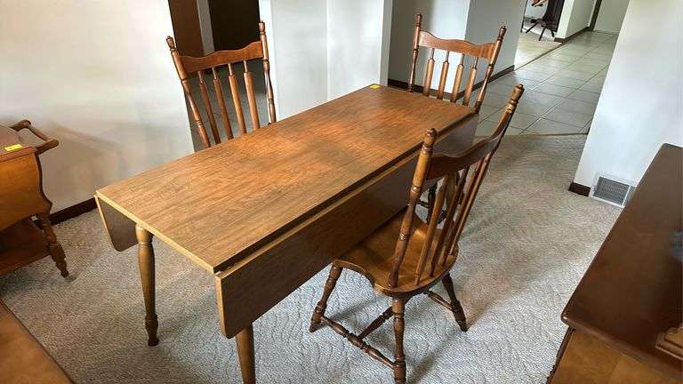 59x23 maple Formica top drop leaf table with (2) 9” extensions, 3 spindle back chairs