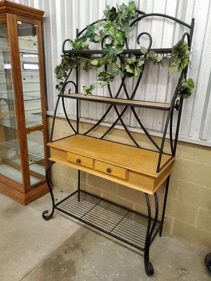 Beautiful wrought iron and wood baker's rack features lower drawer storage and plenty of shelf space. Measures 42 in W X 20 in D X 78 in H. Includes artificial climbing ivy. Small chip in top.
