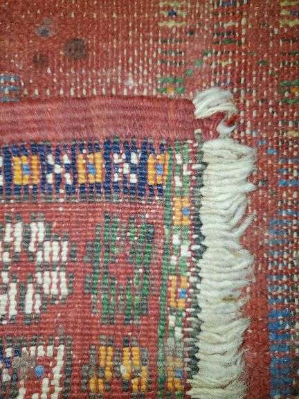 Hand knotted rug featuring center medallion and floral border. Measures 31-in x54 in.