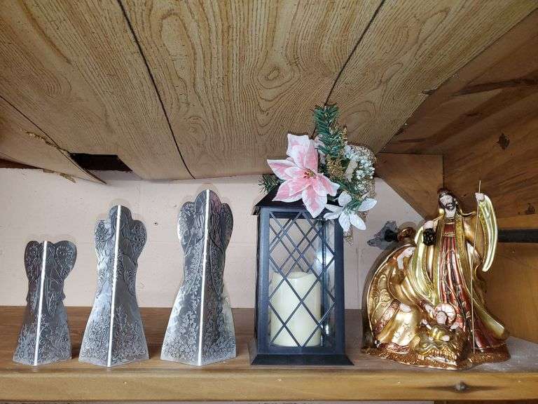 Lot of holiday items including decorative pewter-like angel figures, candle holder, ceramic Christmas manger, Santa Claus figurines, Santa Claus cookie jar, Christmas bells.